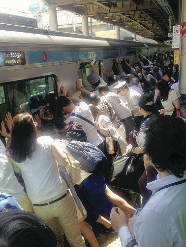 Japanese help a train passenger